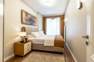 a bedroom with a bed and a window at Bellavia Deluxe Apart in Istanbul +130 photos