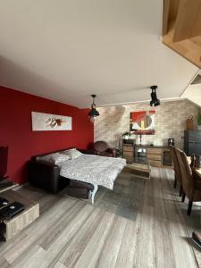 a bedroom with a bed and a red wall at The2 Work or holiday apartment in Godshuis