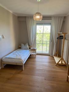 a bedroom with a bed and a large window at Pension Straßl in Andorf