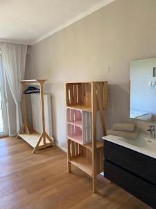 a small room with a sink and a shelf at Pension Straßl in Andorf +19 photos