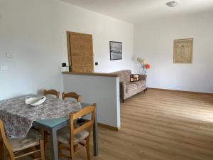 a dining room with a table and a couch at Il Respiro del Brenta in San Lorenzo in Banale