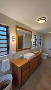 a bathroom with a sink and a mirror at Terganic Farmstay in Grand Sable
