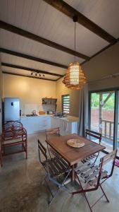a kitchen and dining room with a wooden table and chairs at Terganic Farmstay in Grand Sable