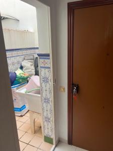 a room with a kitchen with a sink and a door at Andaluz in La Mamola