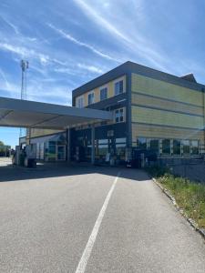 a building with a parking lot in front of it at Pension Straßl in Andorf