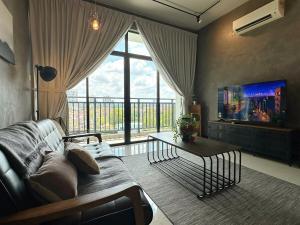a living room with a couch and a large window at Molek Regency Johor Bahru By JC Home in Johor Bahru