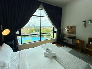 a bedroom with a large bed with a large window at Molek Regency Johor Bahru By JC Home in Johor Bahru +90 photos