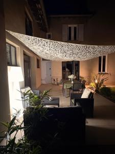 a patio with chairs and a table in a building at Le 1881 Ampuis in Ampuis