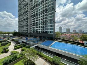 a large building with a swimming pool in front of it at Molek Regency Johor Bahru By JC Home in Johor Bahru