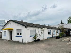 a white building with blue accents on it at TL Gastzimmer 1 in Frankfurt