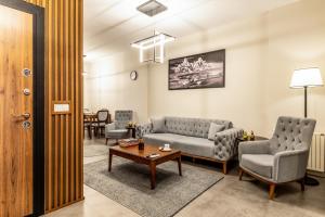 a living room with two couches and a table at Bellavia Deluxe Apart in Istanbul