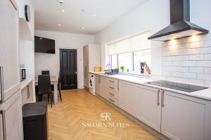 a kitchen with white cabinets and a counter top at Luxury 6BR Ensuite - Contractors & Groups Stay - Parking in Sunderland