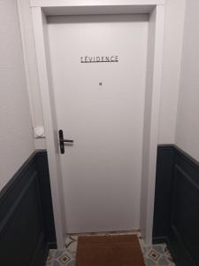 a white door with the word excellence written on it at L Évidence in Thonon-les-Bains