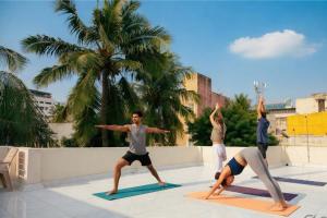 a group of people doing yoga on mats at Hostel Gandhi in Chennai