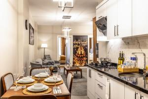 a kitchen and living room with a table and chairs at Bellavia Deluxe Apart in Istanbul