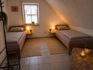 a small room with two beds and a window at tAllhouse drei Räume u Bad in Eggolsheim