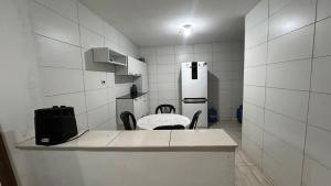 a kitchen with a table and chairs and a refrigerator at Seu lar em Bonito-PE in Bonito +22 photos