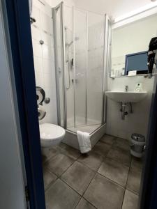 a bathroom with a shower and a toilet and a sink at An der Stadthalle in Braunschweig +45 photos