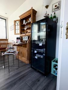 a black refrigerator in a room with a kitchen at An der Stadthalle in Braunschweig