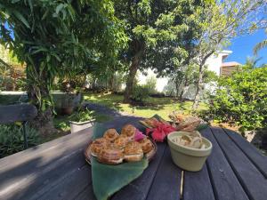 a wooden table with a plate of food on it at Ti case Margot - Maison avec piscine à Manapany in Saint-Joseph