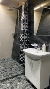 a bathroom with a sink and a shower at Міні-готель аквапарку Европа in Solomonovo +48 photos