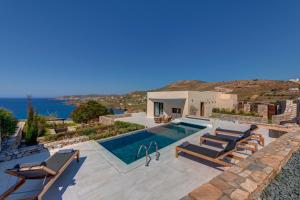 a villa with a swimming pool with a view of the ocean at Pnoe Villas Syros in Megas Gialos - Nites