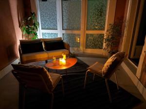 a living room with a couch and a table and chairs at Les Terrasses Sainte Odile - Centre ville - Climatisation - Parking Privatif - Gare in Obernai
