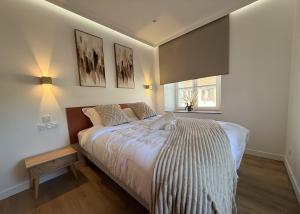 a bedroom with a bed and two pictures on the wall at Les Terrasses Sainte Odile - Centre ville - Climatisation - Parking Privatif - Gare in Obernai
