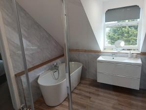 a bathroom with a shower and a sink and a toilet at Bron Orme Private Hotel in Llandudno +100 photos