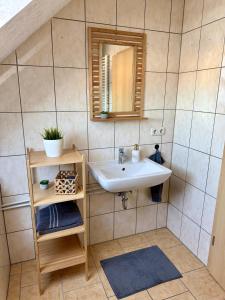 a bathroom with a sink and a mirror at Ferienwohnung Carla in Weißensee