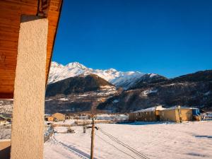 a view of a snowy mountain range from a cabin at Ninama in Mestia