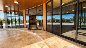an empty lobby of a building with large glass windows at Office Villas Costinesti in Costinesti