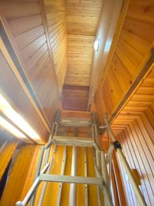 an overhead view of a ladder in a wooden attic at Résidence Le Sporting Cabourg in Cabourg