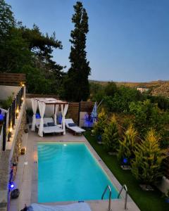 a swimming pool in a backyard with a table and chairs at Elia Paradise Villa with private Pool in Heraklio