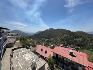 an overhead view of a city with mountains in the background at Singh Kainchi Dham Villa in Bhowāli
