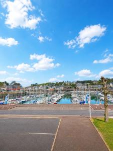 a tennis court next to a marina with boats at Elegance Bretonne in Pléneuf-Val-André