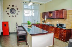 a kitchen with a counter and a red refrigerator at Nadyapartment in Dodoma