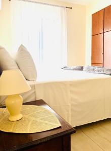 a bedroom with a bed and a table with a lamp at Holiday Dream Thalia Apartment in Mastihari