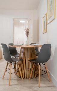 a dining room with a wooden table and chairs at The Graoully's Cave - Hyper Centre in Metz