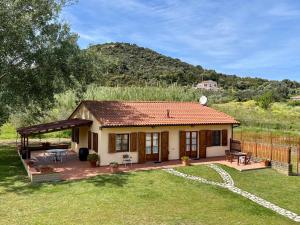 a small house with a patio and a fence at Podere Il Ritorno in Portoferraio +61 photos