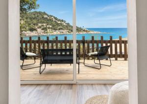 a view of the ocean from a balcony with a table and chairs at Seaside Apartment in Conca