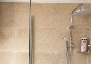 a shower with a glass door in a bathroom at Seaside Apartment in Conca +21 photos