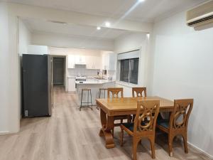 a kitchen and dining room with a table and chairs at Spacious and Comfortable Queen Room - NM1 in Merrylands +9 photos