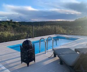 a small swimming pool with a table and a bench at El Mirador de La Duquesa in Mámoles