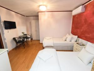 a hotel room with two beds and a table at Vila Magica in Constanţa