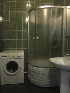 a shower in a bathroom with a washing machine and a sink at Genuez in Odesa +41 photos