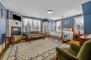 a bedroom with blue walls and a bed and a fireplace at Inn at Jackson in Jackson