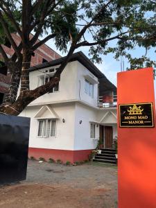 a house with a sign in front of it at Mong Mao Manor in Guwahati