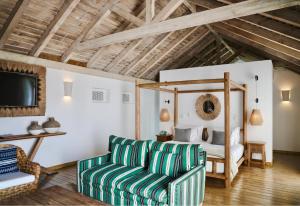 a living room with a couch and a bed at Quinta Da Comporta - Wellness Boutique Resort in Comporta