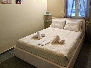 a bed with two pairs of slippers on it at Elia Paradise Villa with private Pool in Heraklio +31 photos